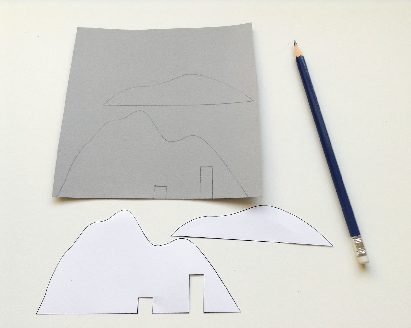 Draw the mountain shapes onto some grey card