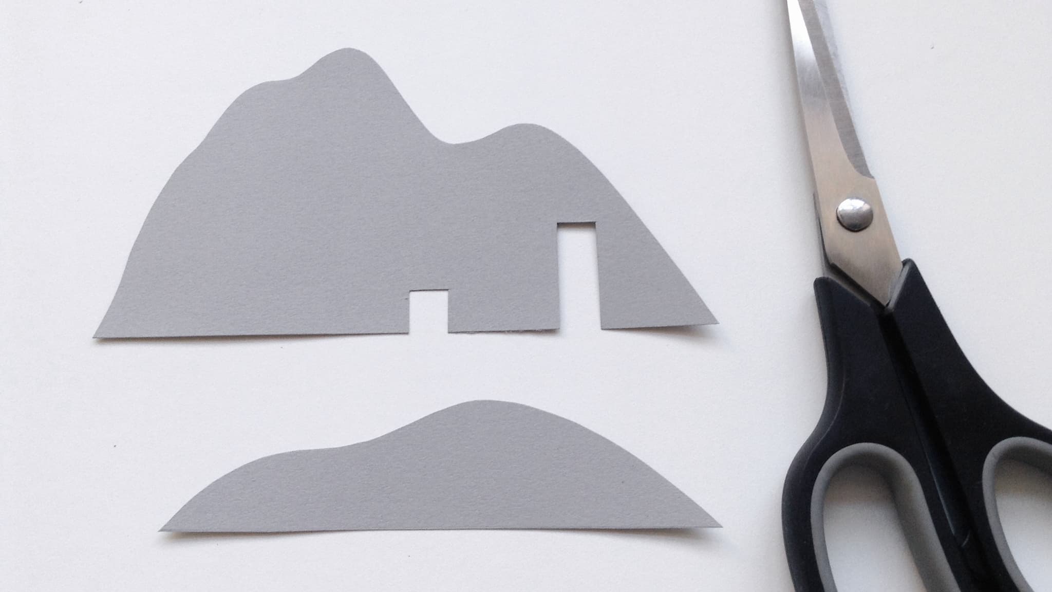 Cut out the mountain shapes from the grey card