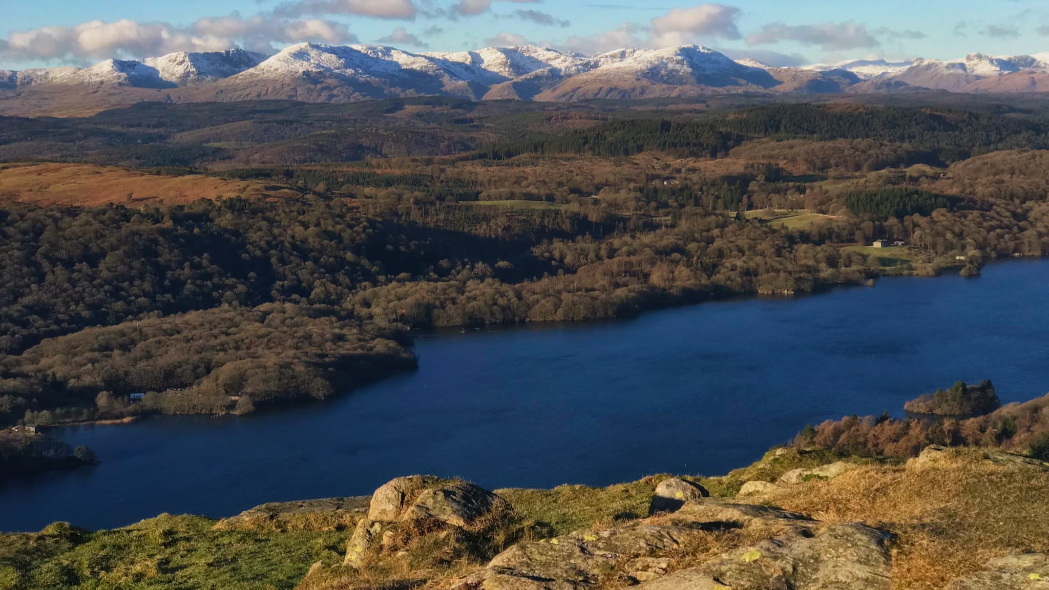 The view looking west from from the summit of Gummer's How, looking at the snow-topped fells of the Lake District, especially the Coniston fells