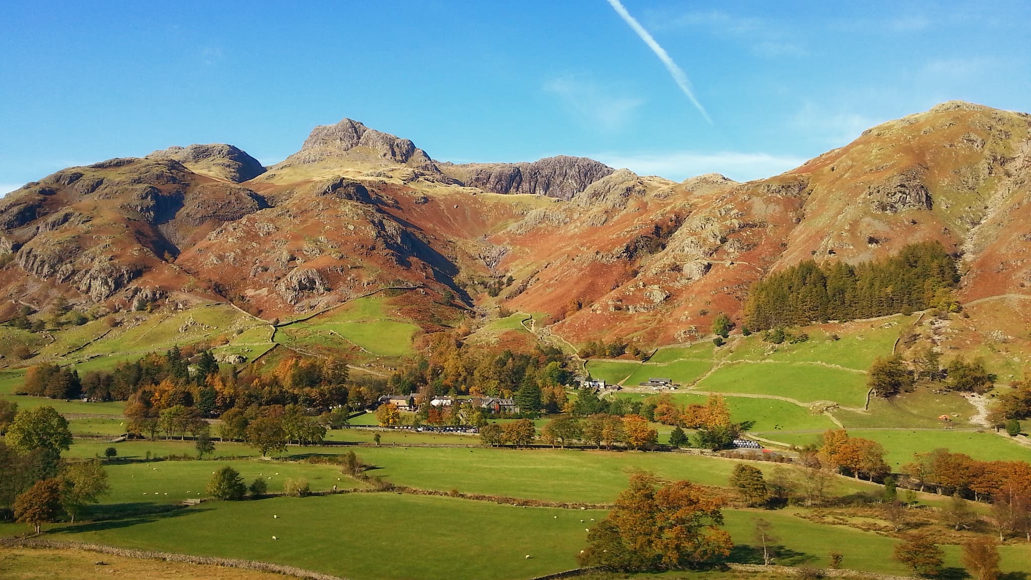 The Langdale Pikes in full autumn colours on a clear blue sky day