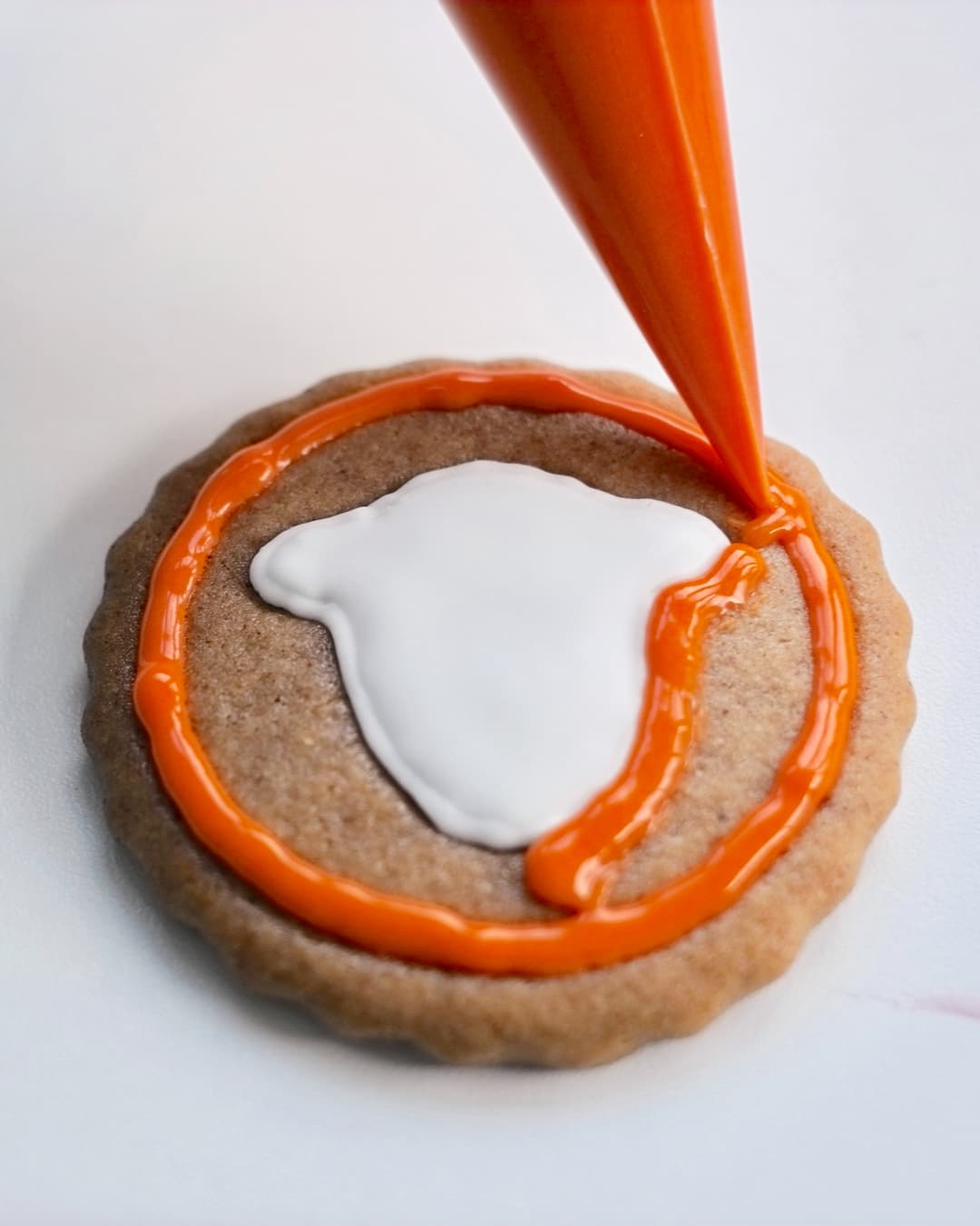 Outline the circle of the gingerbread cookie then fill in with your colour choice