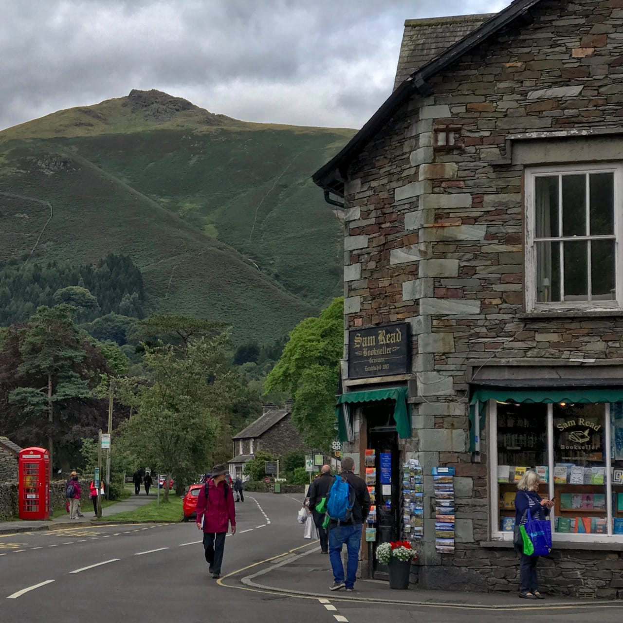 The front of Sam Read Bookshop with the looming summit of Heron Pike in the distance