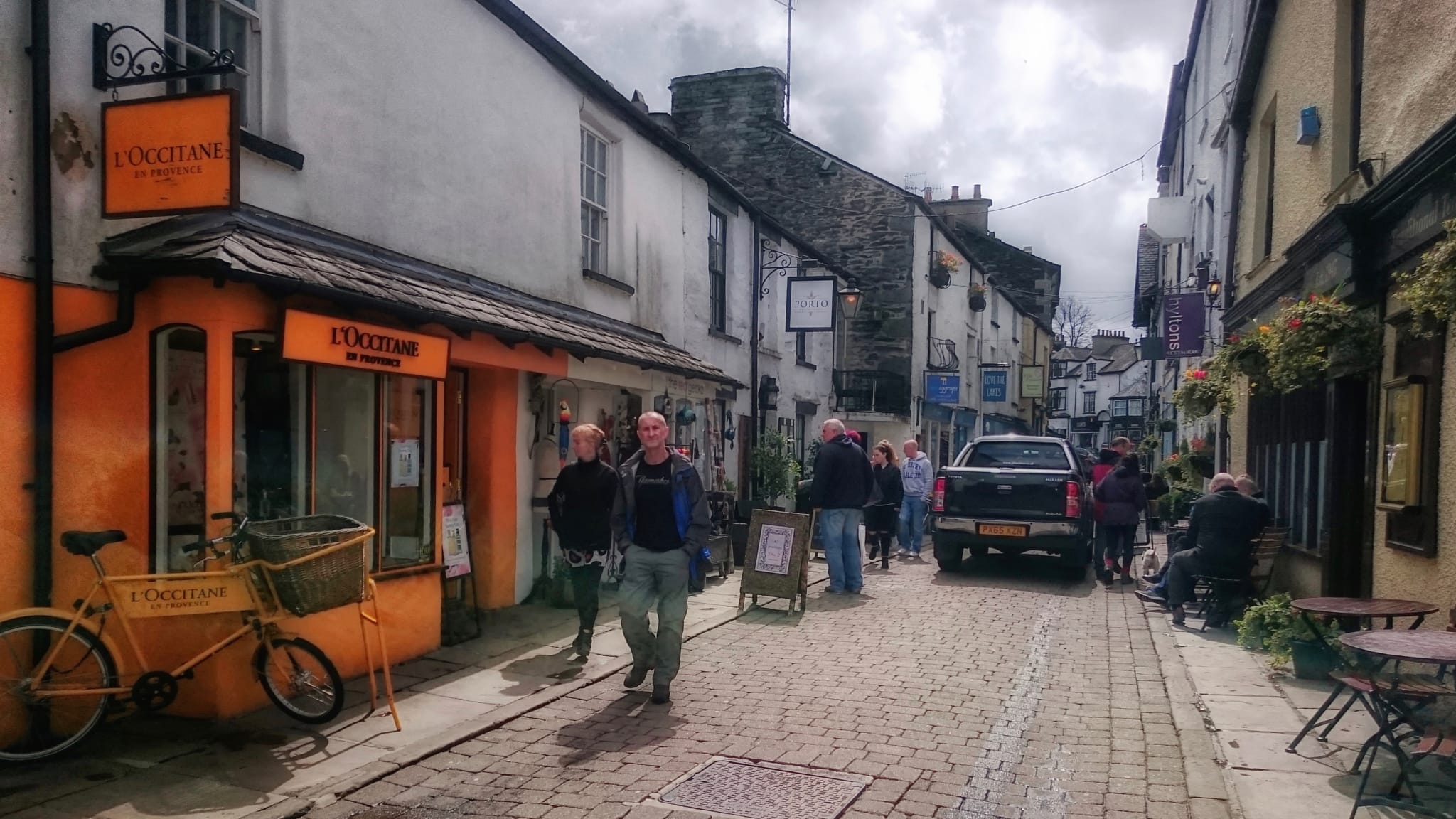 The cobbled lane of Ash Street off Crag Brow in Bowness-on-Windermere, narrow and full of shops.