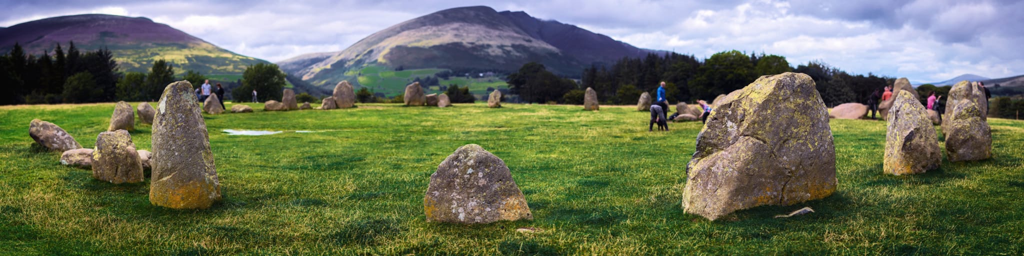 An ultra-wide panorama of Castlerigg Stone circle, with Blencathra and Lonscale Fell looming behind.