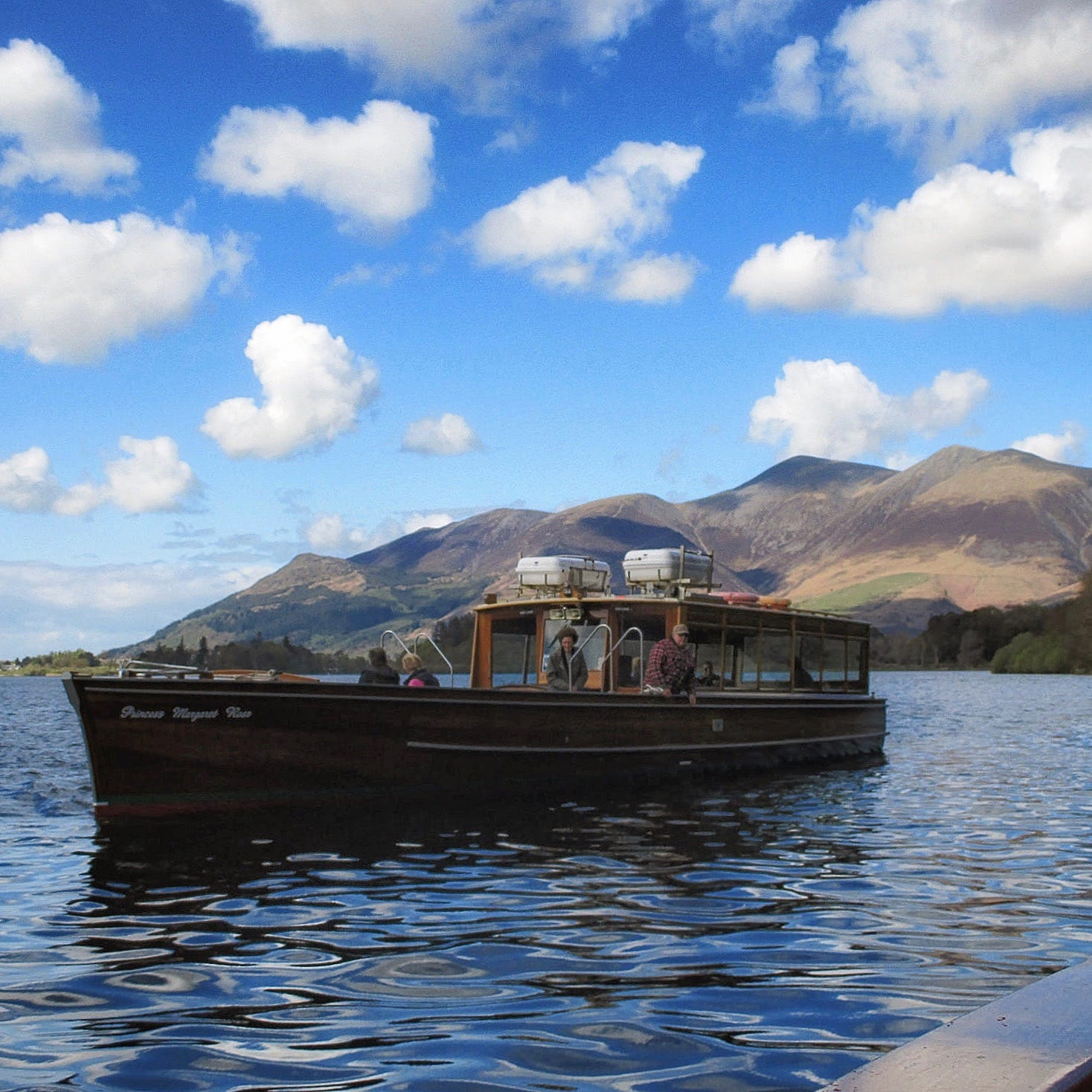 The "Princess Margaret Rose", photographed just off Ashness landing stage two miles south of Keswick. The mountain behind it is Skiddaw. Photo by Antiquary, licensed CC-by-SA-4.0.