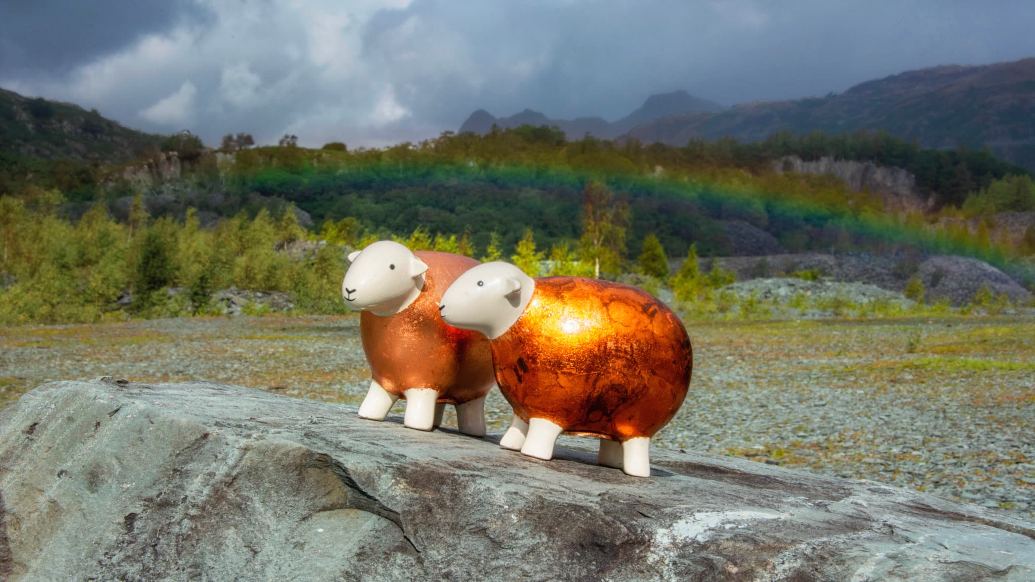 Two copper-gilded Herdys enjoy the sights of Hodge Close Quarry with a rainbow in the background