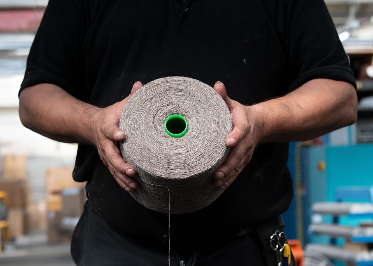 The wound yarn is loaded onto a warp drum, ready for warping