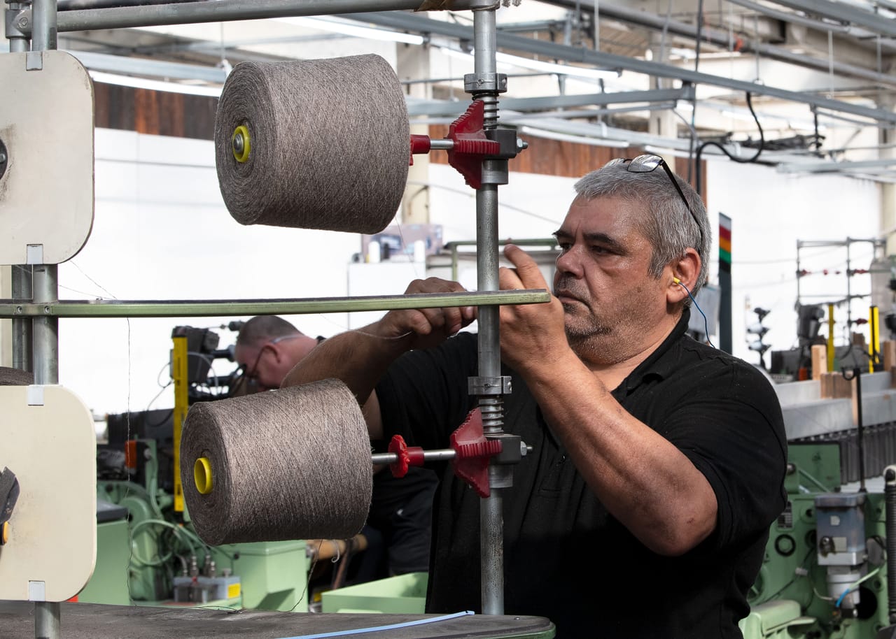 The wound yarn is loaded onto a warp drum, ready for warping