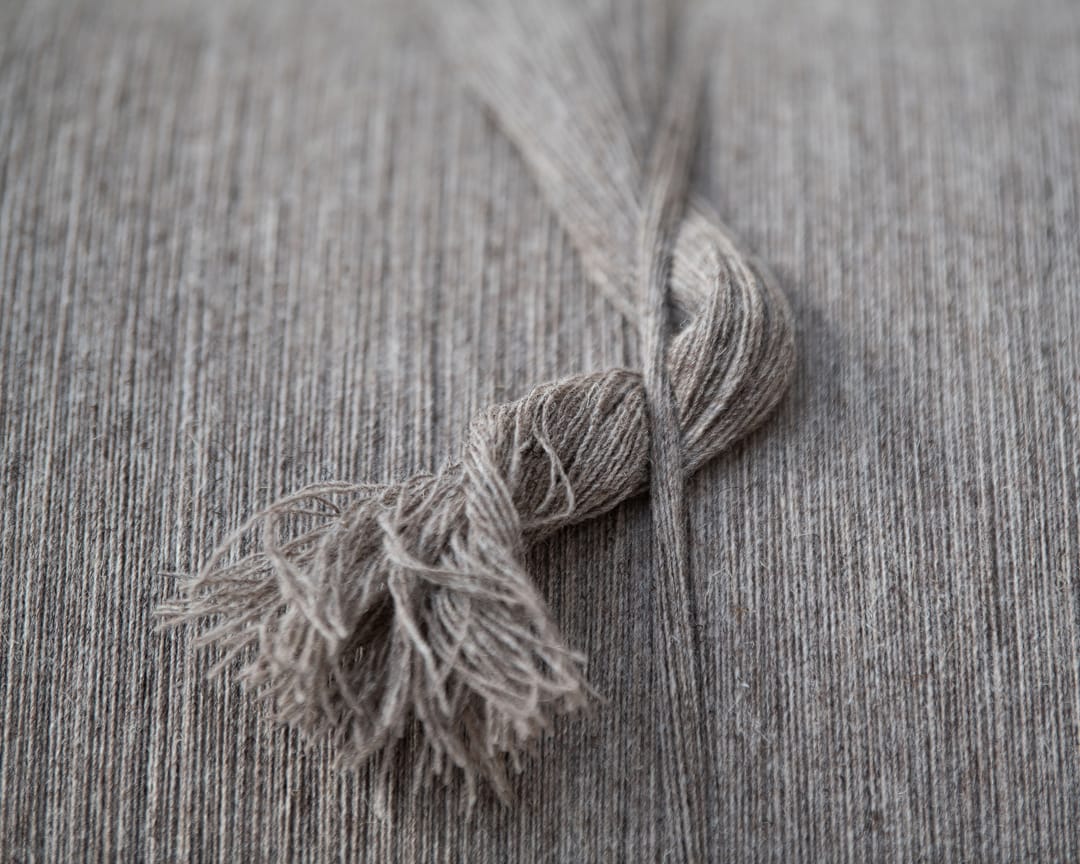 From the warping drum, the fibre is fed off onto the looms