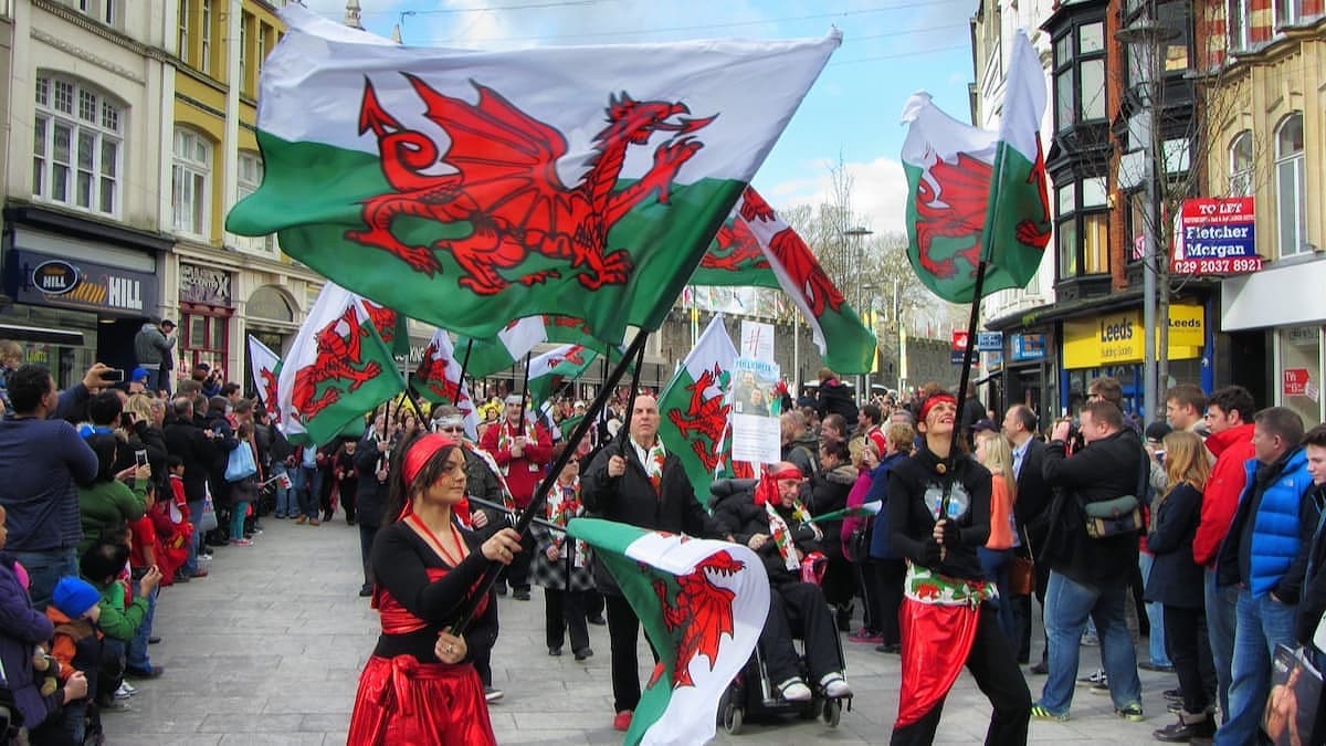 St. David's Day parade, Cardiff. A riot of Welsh flags is seen on St. John Street.