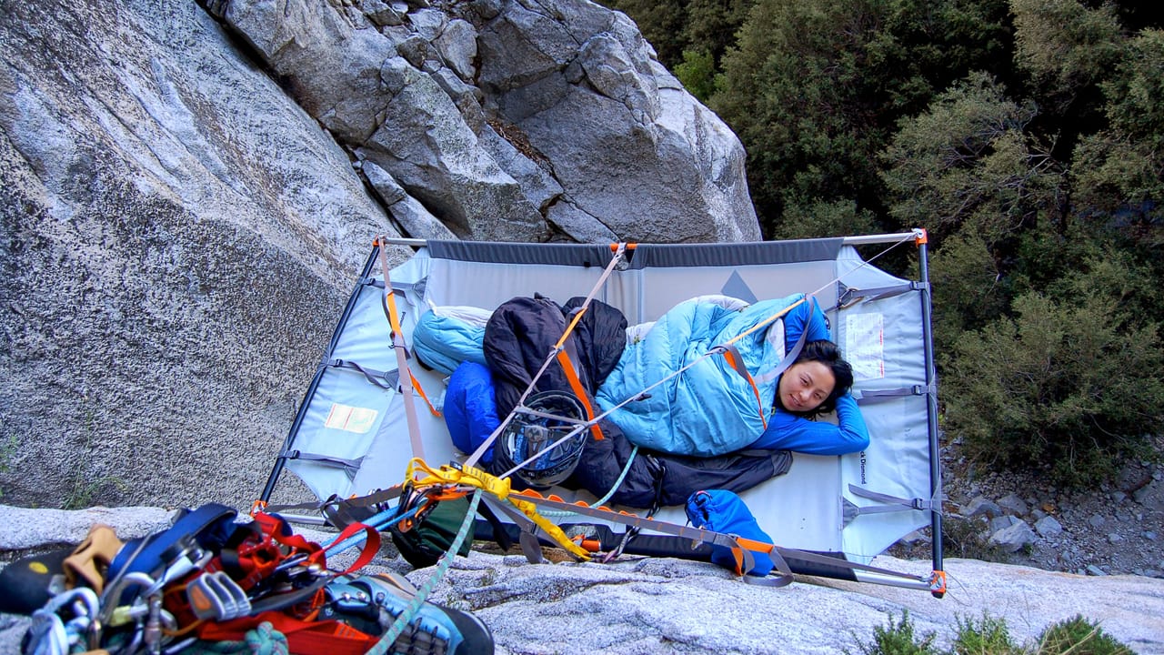 A woman lying on a portaledge. Photo by Maria Ly, licensed CC-by-2.0