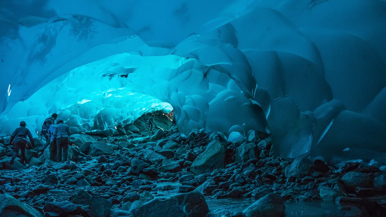 This is Lauren in an ice cave under the Mendenhall Glacier near Juneau, Alaska. Photo by Andrew Russell, licensed CC-2.0