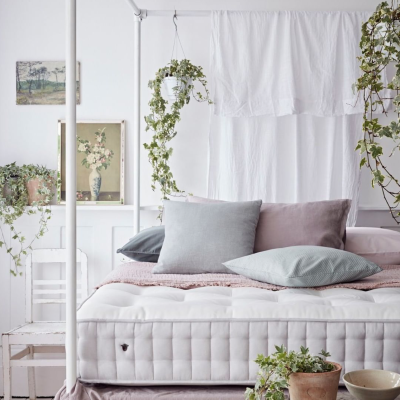 Herdysleep Mattress in a pink and white bedroom, the mattress sits in a fourposter bed.